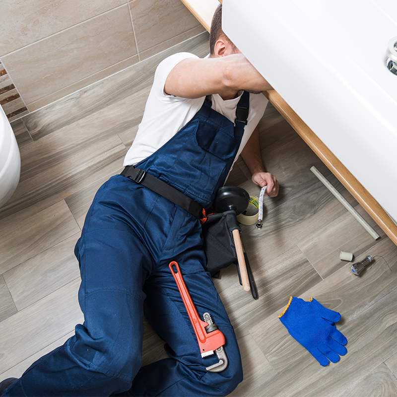 man under sink